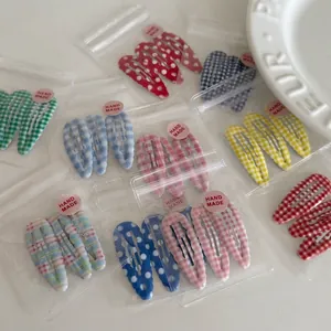 Colorful plaid and polka dot BB hair clips for girls in various pastel patterns