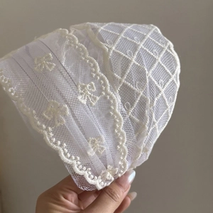 Elegant beige floral lace headband with pearl accents and delicate embroidery details