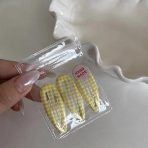 Three yellow checkered wavy hair clips in a clear hand made gift packaging set