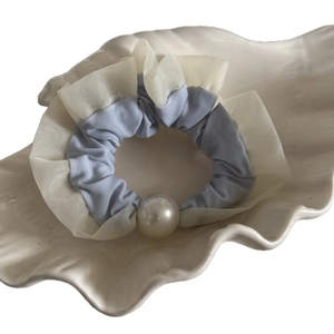 Blue mesh scrunchie with large pearl detail on shell tray for elegant hair styling