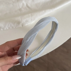 Light blue braided headband with twist design and textured fabric for women