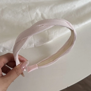 Light pink twisted fabric headband with anti-slip teeth and minimalist retro design