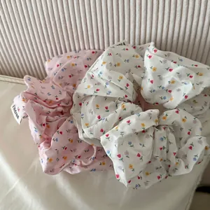 Floral print scrunchies in pink and white fabric with K'orea label detail
