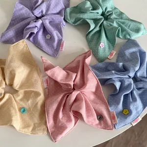 Polka dot scrunchie set with ribbons and flower buttons in assorted pastel cream colors