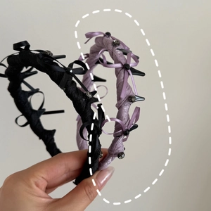Detail of ballet style headbands featuring silk texture bows and rhinestone accents
