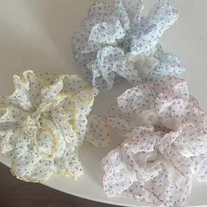 Three-piece floral chiffon scrunchie set in yellow, blue and pink with wavy edges