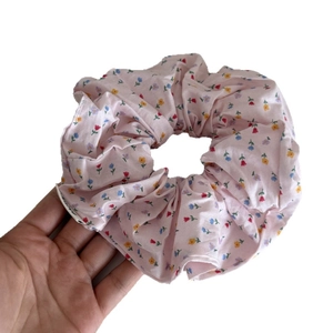 Pink floral fabric scrunchie with small colorful flower patterns for women hairstyles