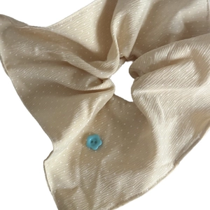 Cream polka dot scrunchie with blue flower button detail for daily hair styling