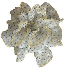 Floral bubble hair scrunchie with black arrow patterns and yellow wavy embroidery edges