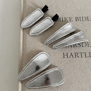 Minimalist silver faux leather hair clips in geometric shapes for a modern hair style