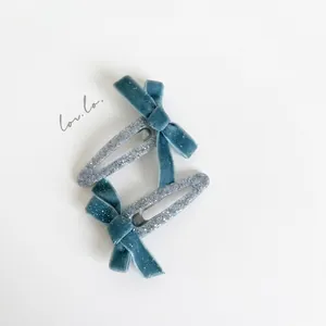 Set of two silver glitter BB hair clips with light blue velvet bows for women