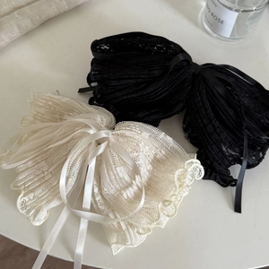 Elegant large lace bow hair claws in black and beige with delicate ribbon and mesh texture