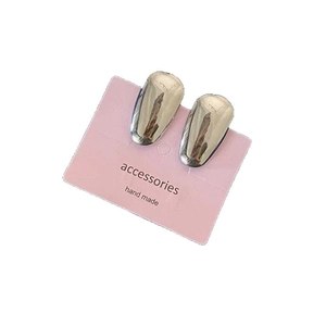 Polished silver teardrop stud earrings displayed on a minimalist accessory card