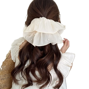 Elegant oversized beige mesh scrunchie with pleated layers and pearl bead accents