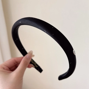 French style black padded headband with sparkling silver glitter and metal logo charm