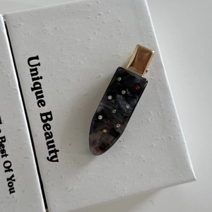 Elegant marble texture acetate hair clip with colorful crystals on a white gift box