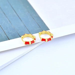 Detailed macro view of S925 sterling silver stamp on golden bamboo enamel hoop earrings