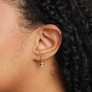 Elegant gold heart drop hoop earrings with star diamond accent on model ear