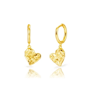 Detail of gold heart earrings showing hammered metal texture and polished finish hoops
