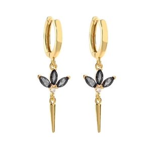 Detail of gold dangle earring featuring black marquise stones and a sharp conical pendant