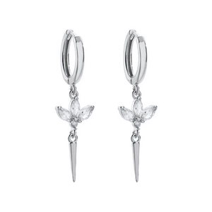 Macro detail of silver needle earrings featuring crystal petals and a conical metal drop