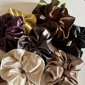 Luxurious satin oversized scrunchies in various colors with handmade label detail