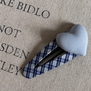 Close-up of blue plaid fabric BB hair clip with light blue padded heart decoration