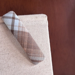 Detailed view of the sea salt blue plaid fabric texture on a vintage hair clip