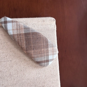 Close-up of brown plaid fabric hair clip with a vintage cotton linen texture finish