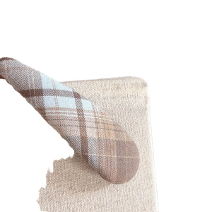 Blue and brown plaid checkered hair clip on beige fabric with vintage British style