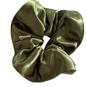 Olive green satin scrunchie with a silk-like finish and a white Hand Made label tag