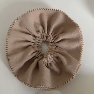 Minimalist khaki suit fabric hair scrunchie with detailed ruffled edges on white background