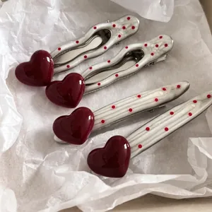 Elegant 4-piece red heart and polka dot pearl hair clips in a French chic style set