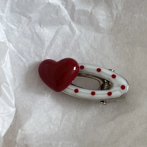 Sweet red heart and polka dot pearl hair clip with silver spring base on white background