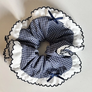 Navy blue checkered scrunchie with white ruffles and two elegant silk bow details