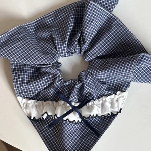 Blue and white plaid scrunchie with lace ruffle edge and navy ribbon bow hair tie