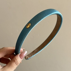 Lustrous blue satin headband with thick padding and golden love metal accent accessory