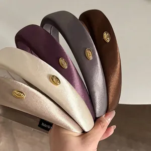 Set of five padded silk headbands with gold Korea metal labels for a high skull top look