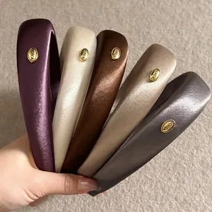Padded satin headbands in five colors with a gold-tone Korea metal tag for women