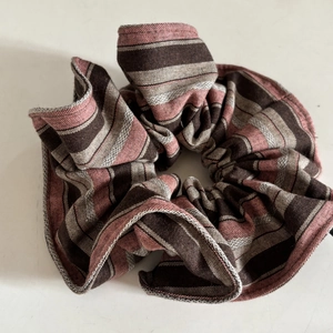Vintage striped scrunchie with retro pink and brown fabric folds on white background