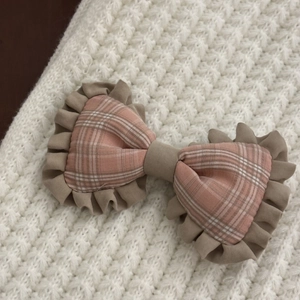 Sweet handmade plaid fabric bow hair clip with ruffle lace on a white knit background