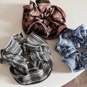 Set of three vintage striped scrunchies in reddish brown, grey, and blue colors