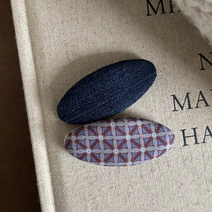 Navy denim and red geometric pattern fabric hair clips for girls on a vintage book