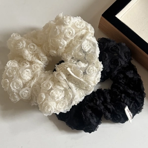 Lace flower scrunchie set with black and white 3D rose patterns and small brand tags