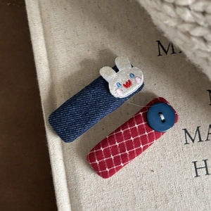 Handmade fabric hair clips featuring blue denim rabbit and red gingham with button
