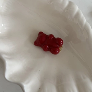 Pince à cheveux ours ambré avec base en métal doré sur coupelle en céramique blanche