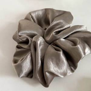 Elegant champagne gold oversized satin scrunchie with high gloss silk finish