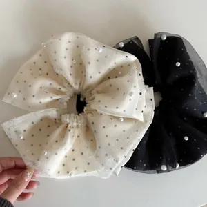 Gros plan de chouchous à pois en maille double couche avec accents de perles élégantes