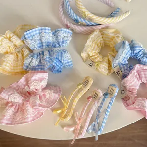 Detail of gingham scrunchies and headbands with lace edges in pastel macaron colors