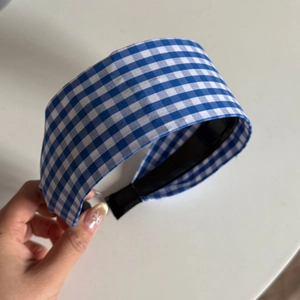 Detail view of blue and white gingham wide headband with soft fabric texture